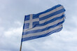 worn flag of Greece on strong wind 
