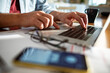 © Marko Geber - Close up of a man typing on the laptop doing online banking