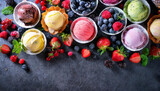Fototapeta Tęcza - Ice cream assortment. Selection of colorful ice cream with berries and fruits on dark rustic table. Top view