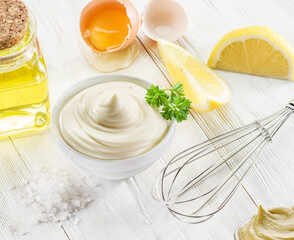 Wall Mural - Homemade mayonnaise with ingredients and herbs.