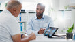 © Wesley/peopleimages.com - Man, doctor and tablet with patient, brain scan or consultation for examination results at hospital. Male person, medical employee or nurse pointing to technology for MRI or x ray at neurology clinic