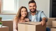 © Elchin Abilov - Smiling young couple opening a carton box and looking inside, relocation and unpacking concept