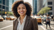 © Sappheiros - Portrait of happy African american business woman on city street urban background. Young professional black woman manager looking at camera