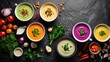 assortment of colored vegetable cream soups on a black stone background. Presented from a top view, highlight the dietary aspect of the food and ensure free space for copy