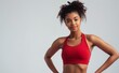 Fit and healthy young black African American woman in red athletic wear, showcasing sports bra in gym attire. Empowerment fitness and active lifestyle fashion concept.