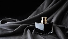 Abstract Black Perfume Bottle On Black Cloth Background
