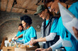 © Drazen - Happy woman packing donated food with group of volunteers at community service center.