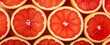 Fresh arranged red grapefruit slices, closeup macro detail from above. Generative AI