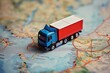 A toy truck is positioned on top of a detailed road map, showcasing a miniature transportation scene.
