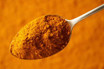 Poster - Turmeric root powder on a metal spoon