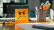 © StockUp - a sticky note with an angry face drawn on it by a disgruntled employee