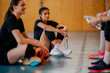 © Zamrznuti tonovi - Portrait of an interracial volleyball player taking a break with her team.