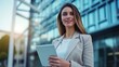 © The Little Hut - Generative AI : Portrait of a successful business woman using digital tablet in front of modern business building