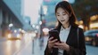 © The Little Hut - Generative AI : Young busy successful beautiful Asian business woman, holding cellphone using smartphone