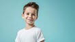 © The Little Hut - Generative AI : Cute smiling boylooking at camera in isolated studio light blue color background