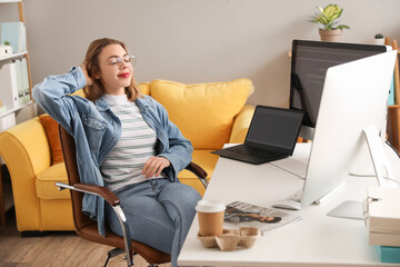 Poster - Female programmer working at table in office