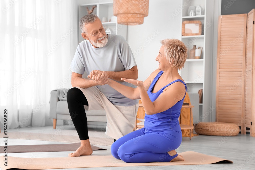 Sporty mature couple training at home