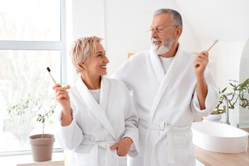 Sticker - Mature couple brushing teeth in bathroom