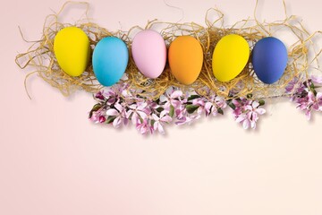 Wall Mural - Easter concept, colored eggs with fresh flowers