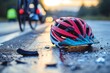 A discarded bicycle helmet lies abandoned on the pavement, a symbol of the thrill and freedom of cycling now left behind