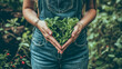A woman in denim overalls gently cradles a bunch of kale, forming a heart shape, symbolizing love for healthy eating and gardening.