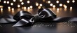 Black satin ribbon bow on sparkling background.