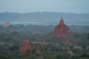 Aerial top view of burmese temples of Bagan City from a balloon, unesco world heritage with forest trees, Myanmar or Burma. Tourist destination.