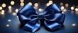 Dark blue satin ribbon bow on sparkling background.