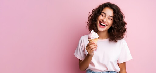 Summer portrait of happy young woman eating ice cream wearing sunglasses on pink background.