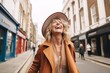 © Stocknterias - Portrait of a happy mature woman laughing in a city street.