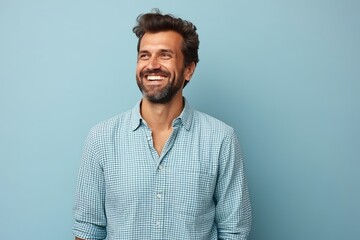 Sticker - Portrait of a happy young man smiling at camera against blue background