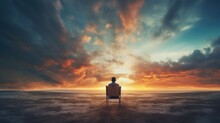 A Lonely Man Sits In A Chair In A Fantasy Landscape With A Shining Cloudy Sky.