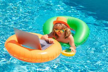 Wall Mural - Work outside with laptop in pool. Kid with laptop in pool water in summer day. Waterproof laptop.