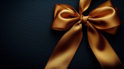 An elegant gold ribbon and bow stand out against a dark background, adding a touch of luxury to any gift or decoration.