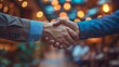 Business partners seal the deal with a firm handshake, signifying a successful agreement and collaboration for future success.