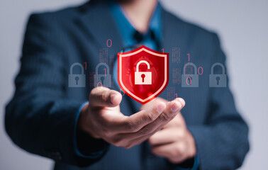 Wall Mural - hacker attack and data breach, information leak concept. businessman hold virtual red protection shi