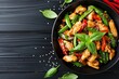 Cook chicken with peppers and beans on black table