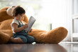 © chokniti - Smiling and happy cute and adorable Caucasian child looking to camera, Portrait of little toddler boy reading book and with joyfully and happiness. Concept of childhood, motherhood bonding health care
