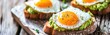 Avocado toast with fried egg on rustic wooden background, healthy breakfast. Banner.