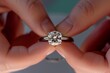 © altitudevisual - hands positioning a diamond into a ring setting