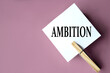 AMBITION - word on white sheets of paper with clothespins on a coffee background
