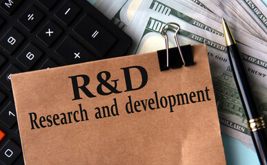 R and D - acronym on brown paper on the background of calculator and banknotes