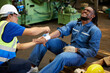 © offsuperphoto - worker first aid and applying bandage on technician arm in the factory