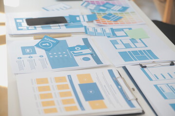 Close up ux developer and ui designer use augmented reality brainstorming about mobile app interface wireframe design on desk at modern office.Creative digital development agency