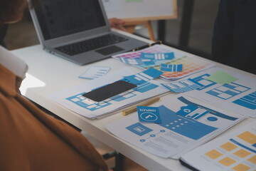 Close up ux developer and ui designer use augmented reality brainstorming about mobile app interface wireframe design on desk at modern office.Creative digital development agency