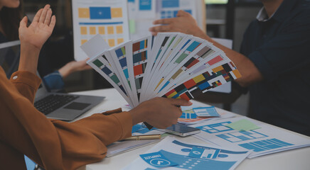 Close up ux developer and ui designer use augmented reality brainstorming about mobile app interface wireframe design on desk at modern office.Creative digital development agency