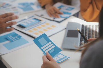 Close up ux developer and ui designer use augmented reality brainstorming about mobile app interface wireframe design on desk at modern office.Creative digital development agency