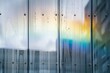 a rainbow appearing in the reflection on a wet glass facade
