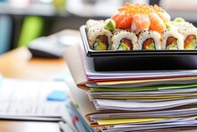 Stack Of Documents With A Sushi Bento Box On Top