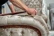 upholsterer carefully stretching velvet over a chaise lounge